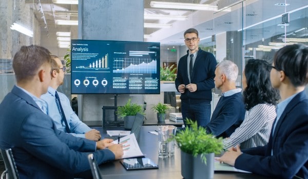 a group of people are discussing in office