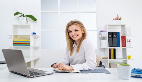 a beautiful girl is sitting in office