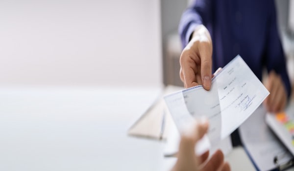 a young man is holding a paper